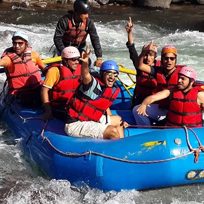 Travelers enjoy river rafting in scenic Shimla-Manali tour packages with beautiful hill views