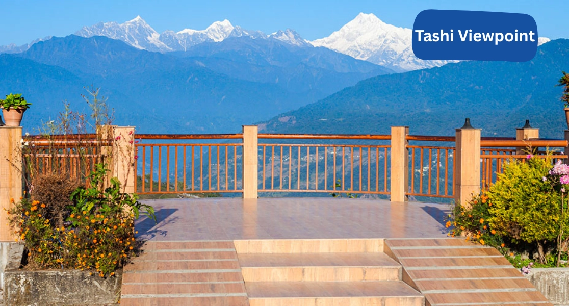 Tourists enjoy panoramic Himalayan scenery at Tashi Viewpoint during a trip from Cochin to Sikkim