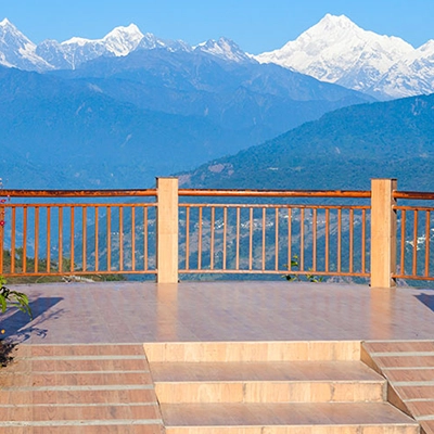 Tourists enjoy panoramic Himalayan scenery at Tashi Viewpoint during a trip from Cochin to Sikkim