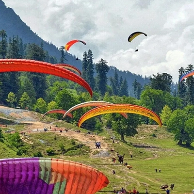  Tourist enjoying a thrilling paragliding ride in Manali as part of an exciting adventure packages